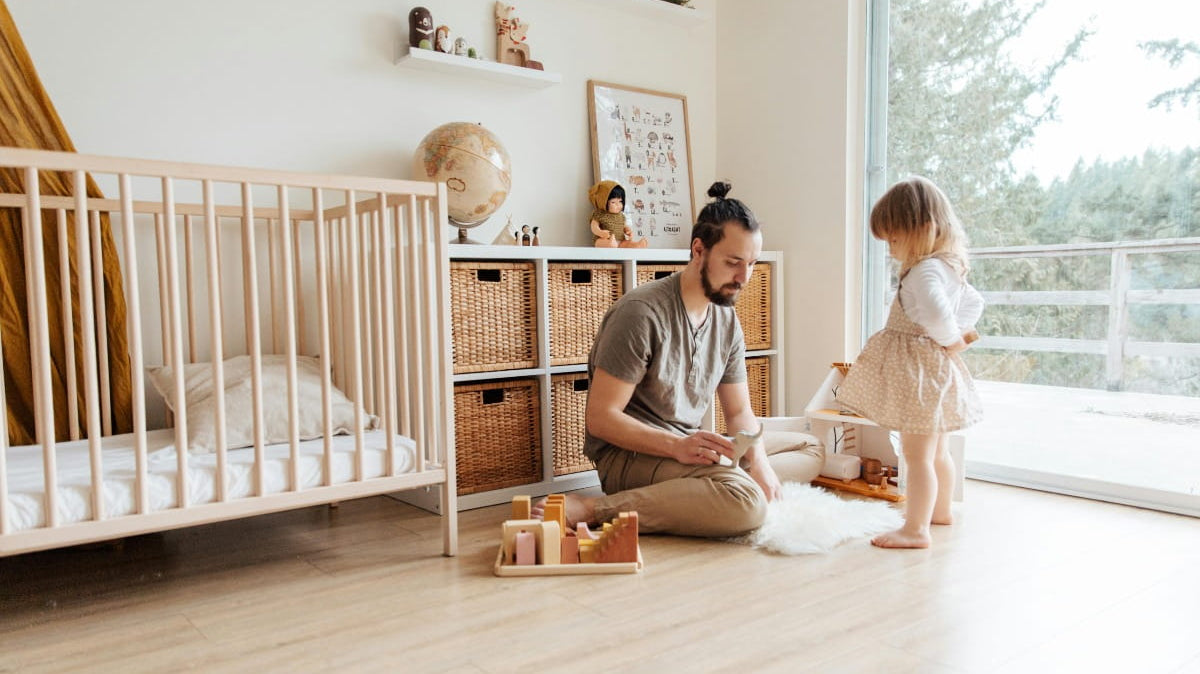 A man playing with a child in a nursery