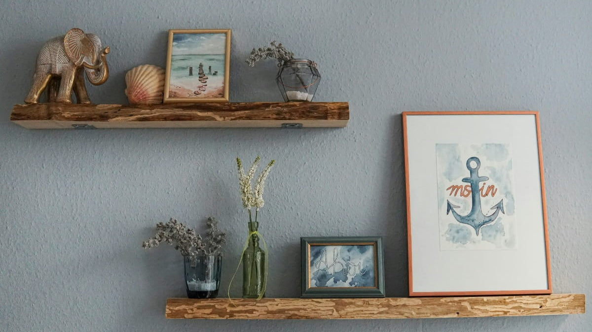 Flowers, glass vase, photos on a wooden wall shelf