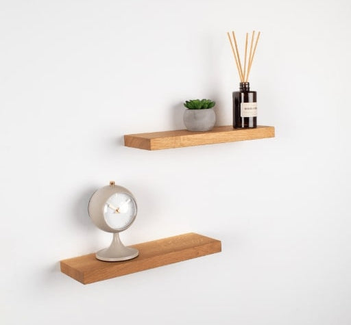 Wooden shelves with decorative items on a white wall