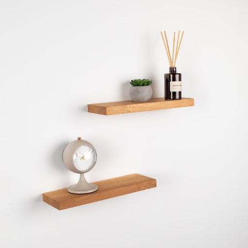 Wooden shelves with decorative items on a white wall