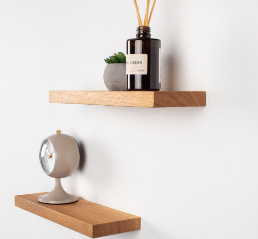 Wooden shelves with decorative items on a white wall