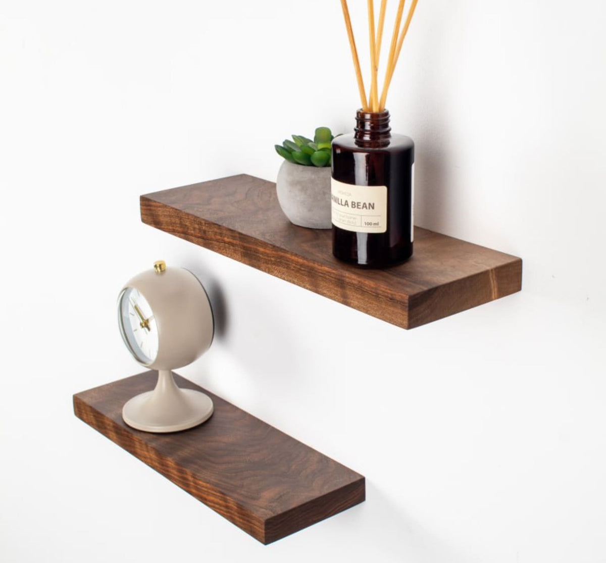 Wooden shelves with decorative items on a white background