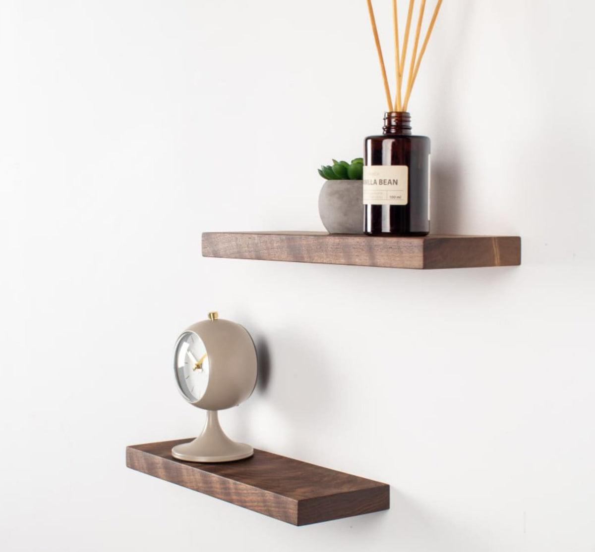 Wooden shelves with decorative items on a white wall