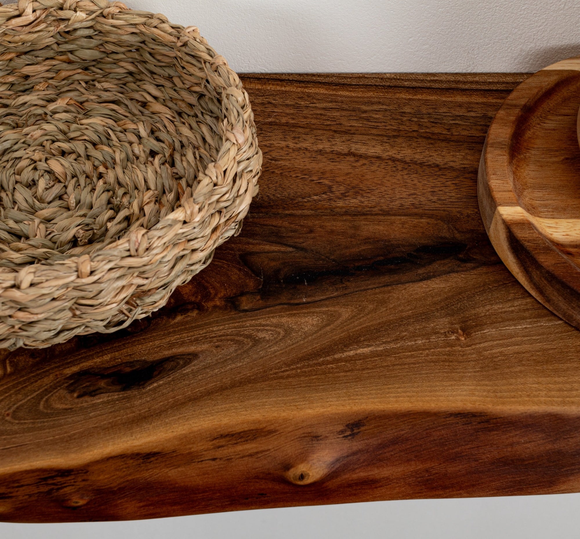 Woven basket and wooden bowls on a wooden surface