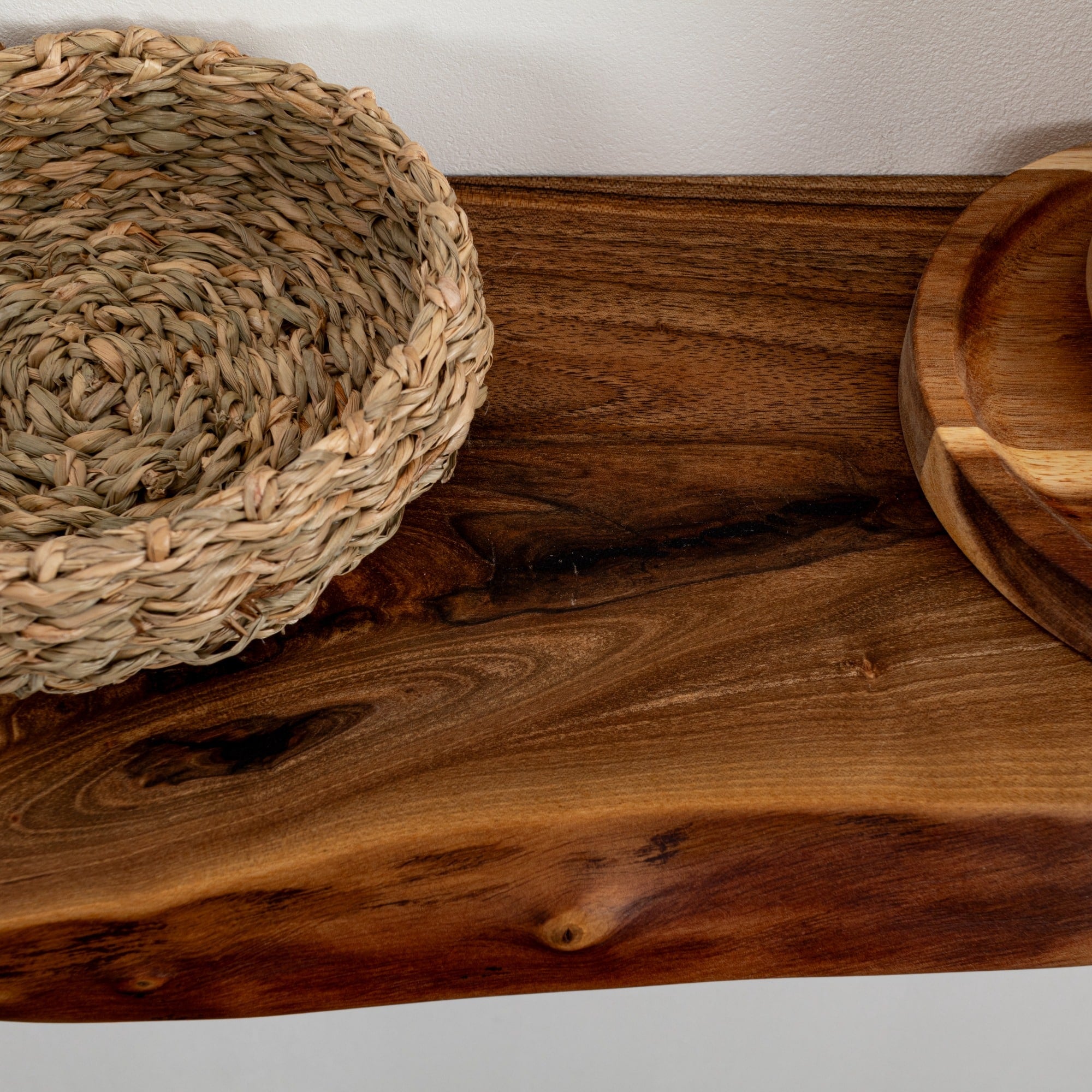 Woven basket and wooden bowls on a wooden surface