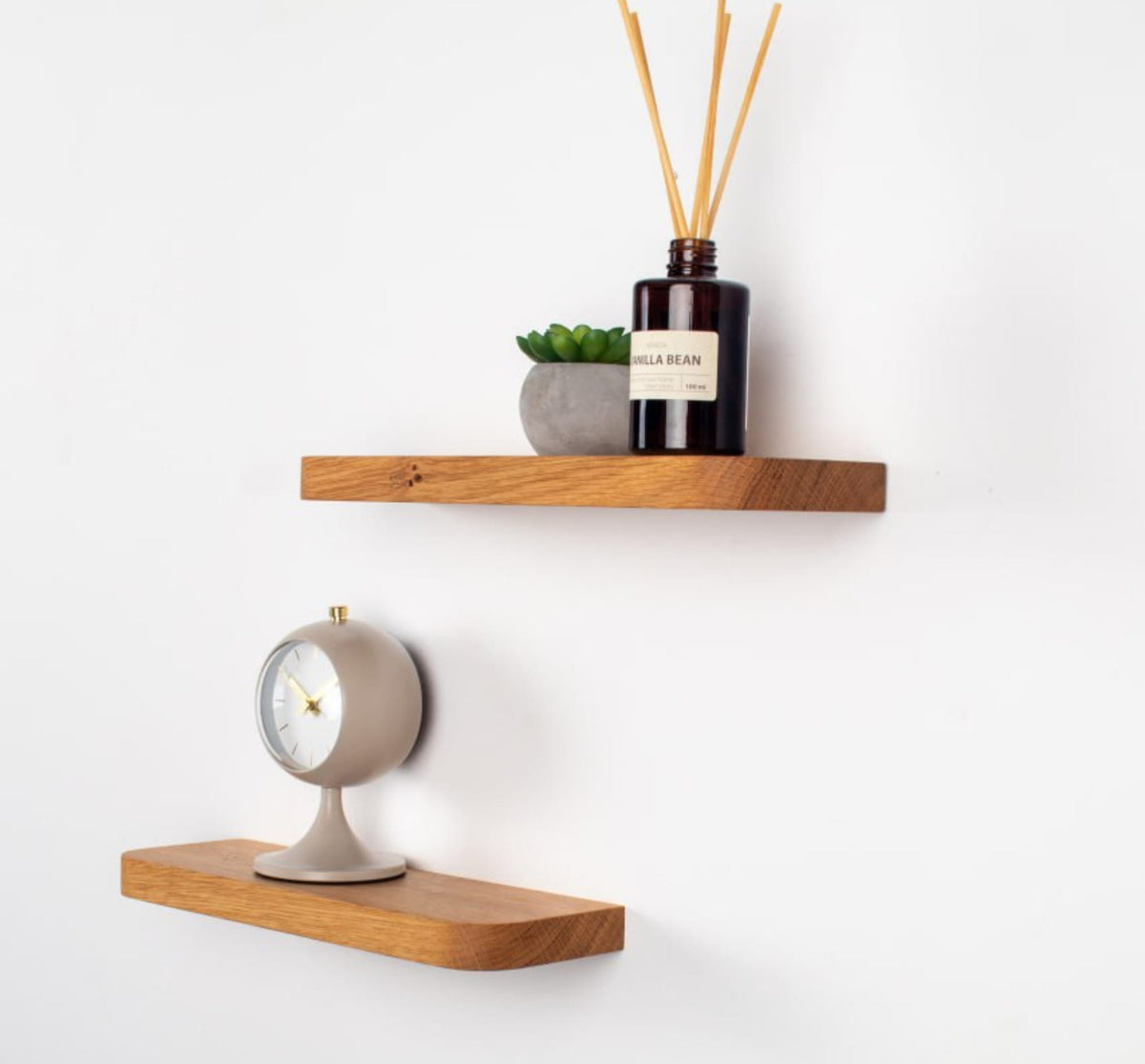 Wooden shelves with decorative items on a white wall