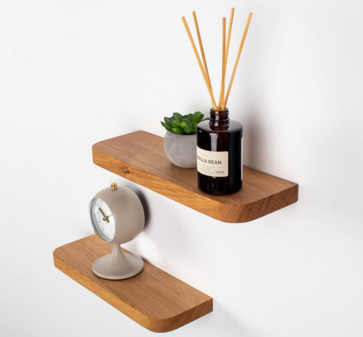 Wooden shelves with decorative items on a white background
