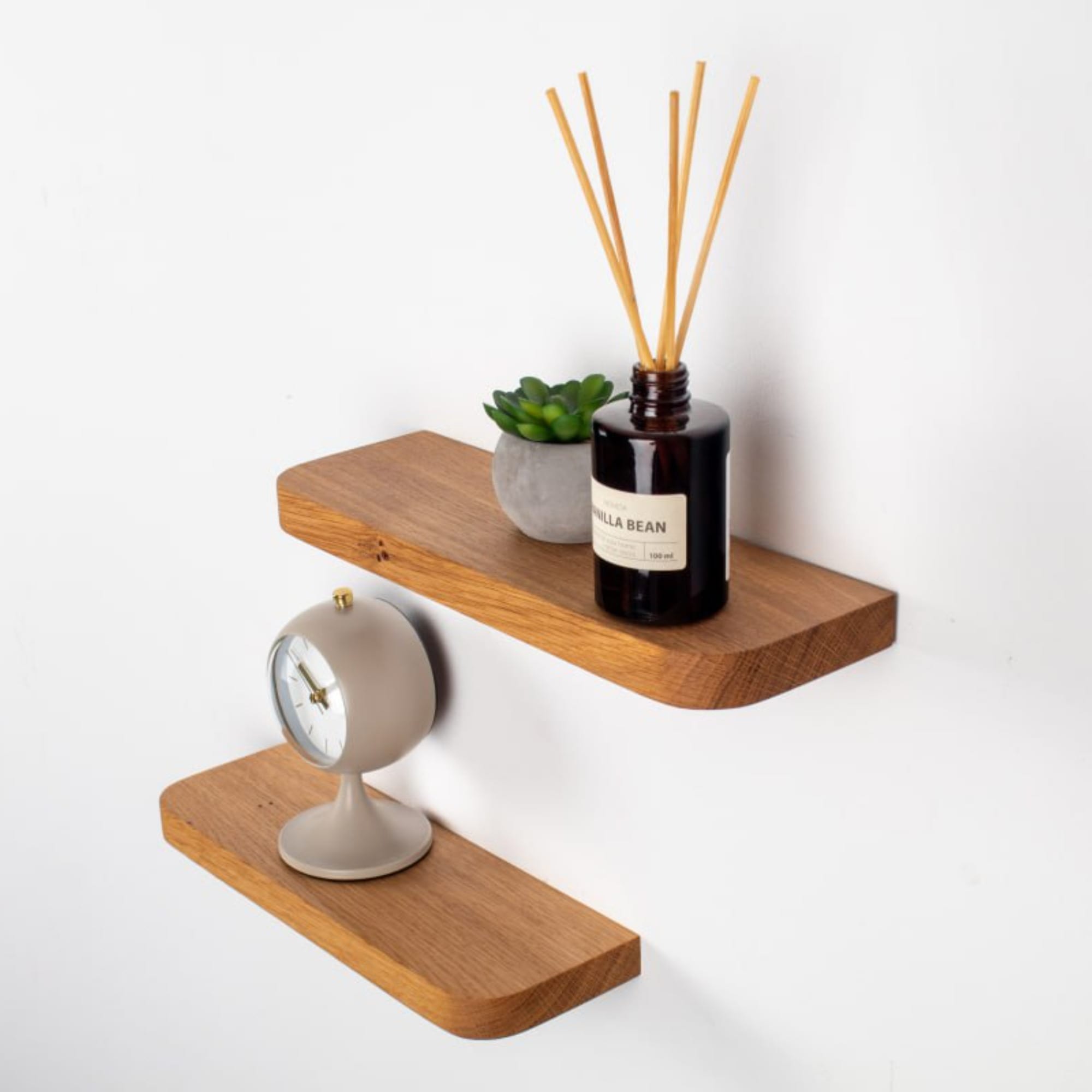 Wooden shelves with decorative items on a white background