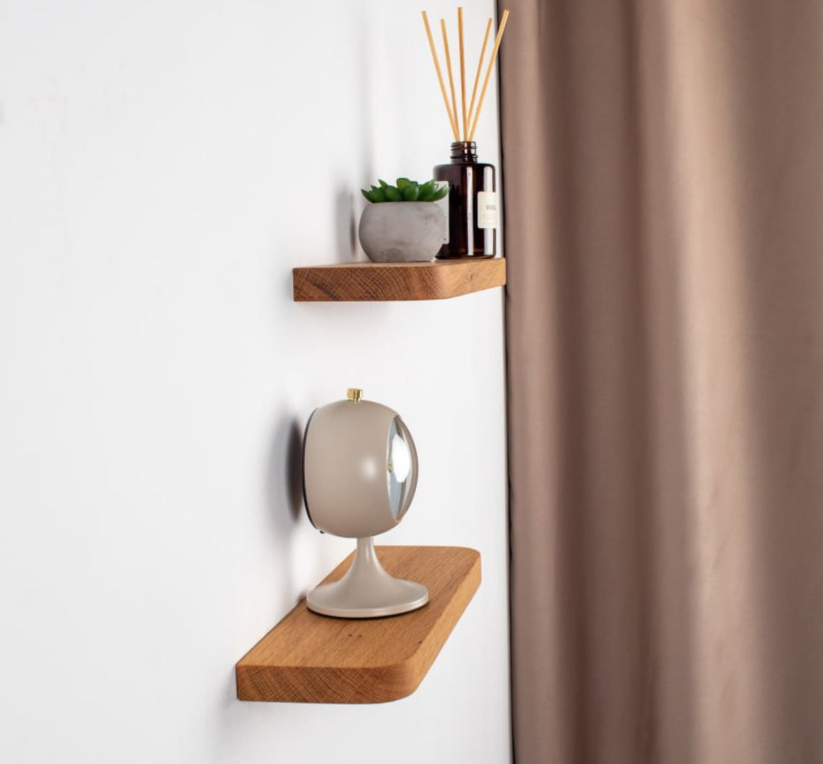 Wooden shelves with decorative items against a white wall.