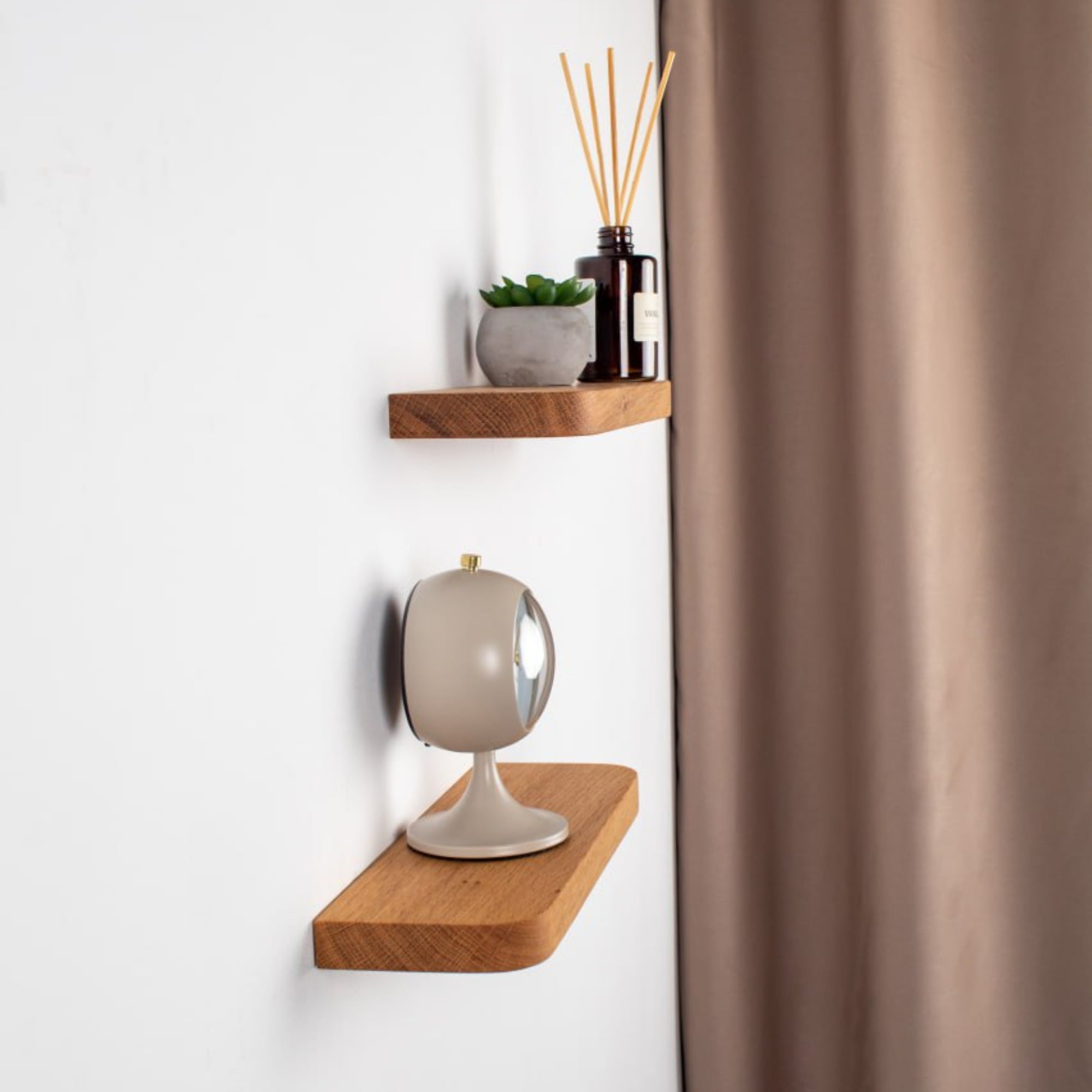 Wooden shelves with decorative items against a white wall.