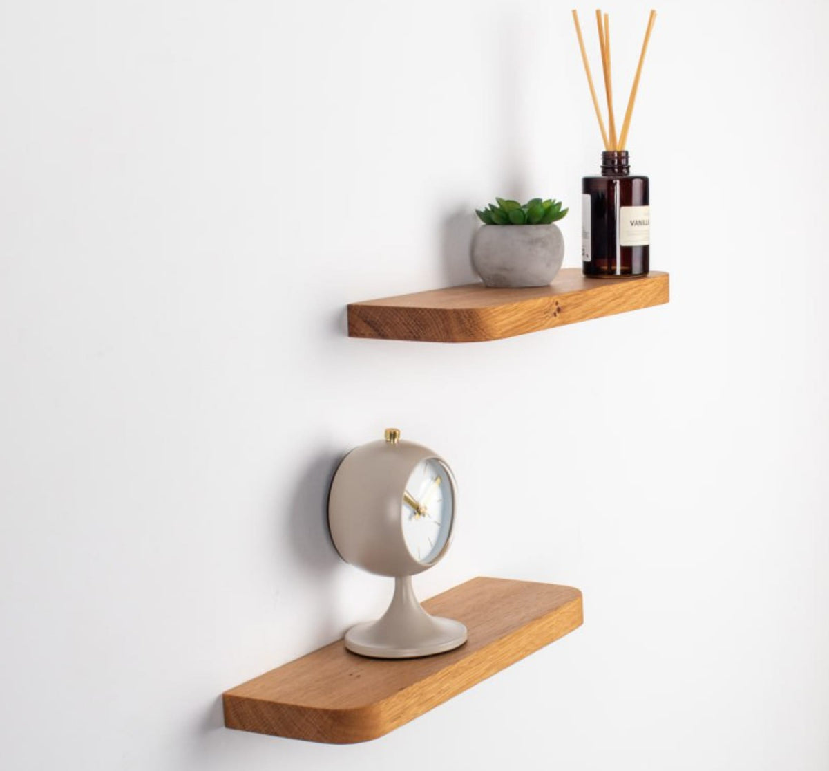 Two wooden shelves with decorative items on a white background
