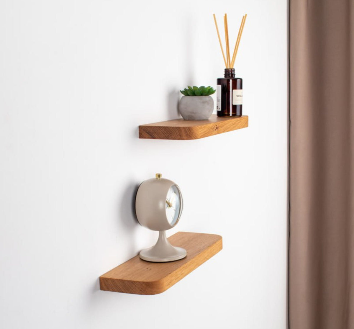 Wooden shelves with decorative items on a white wall.
