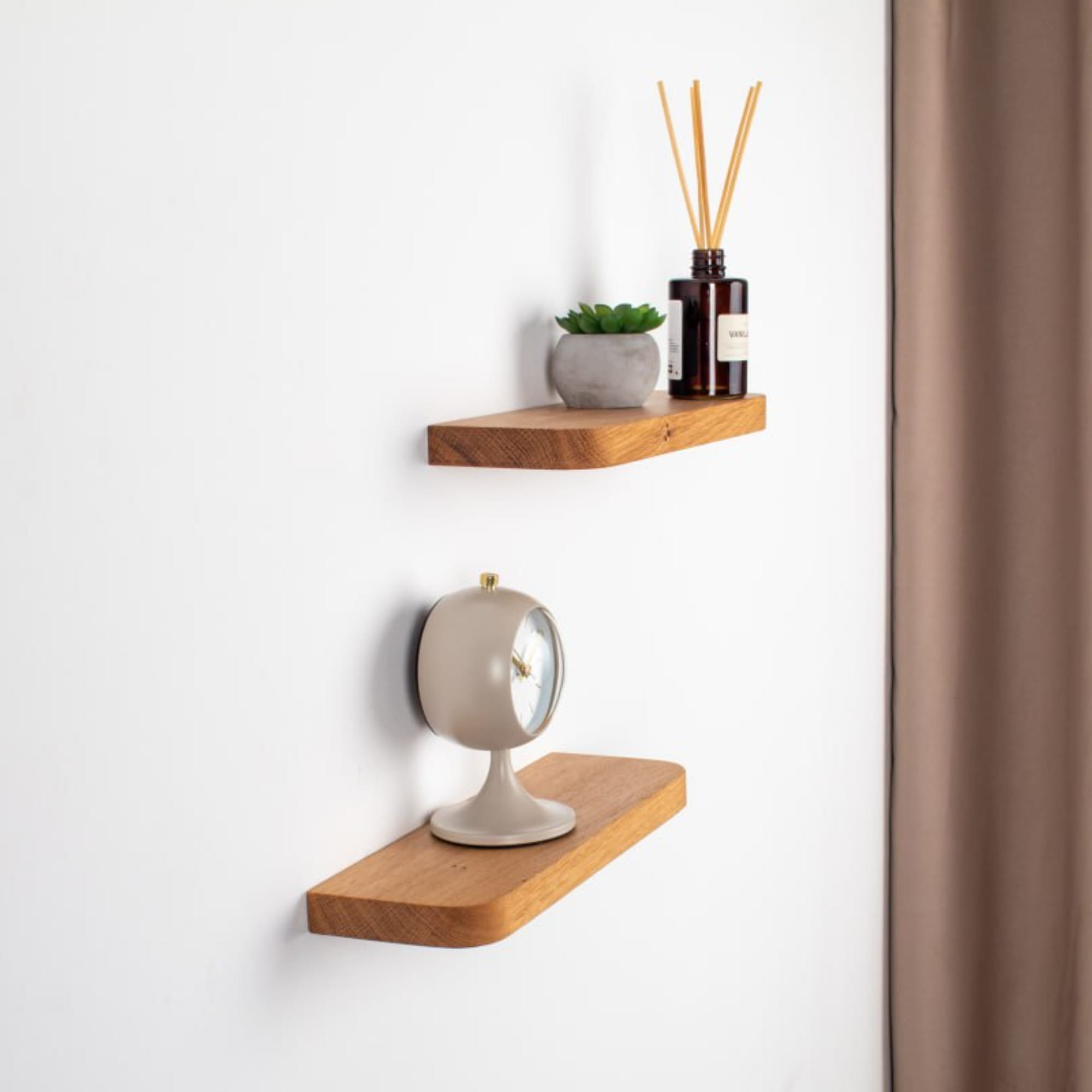 Wooden shelves with decorative items on a white wall.