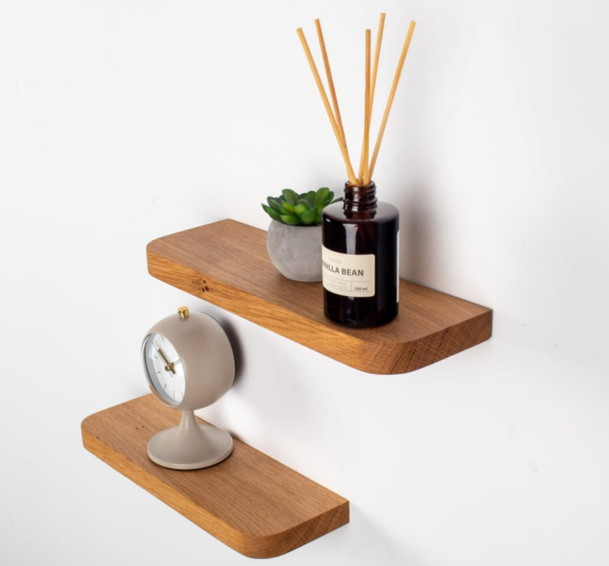 Wooden shelves with decorative items on a white background