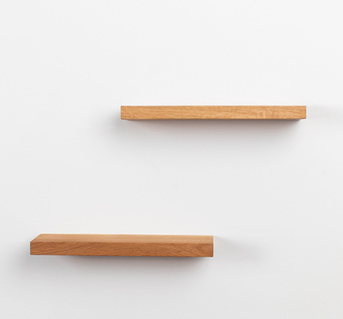 Two wooden shelves on a white background