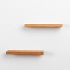 Two wooden shelves on a white background