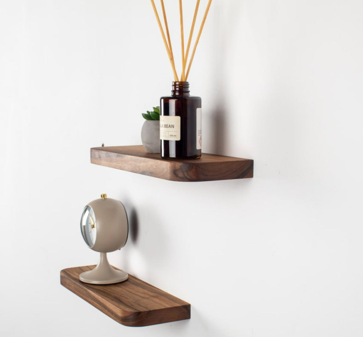 Wooden shelves with decorative items on a white wall