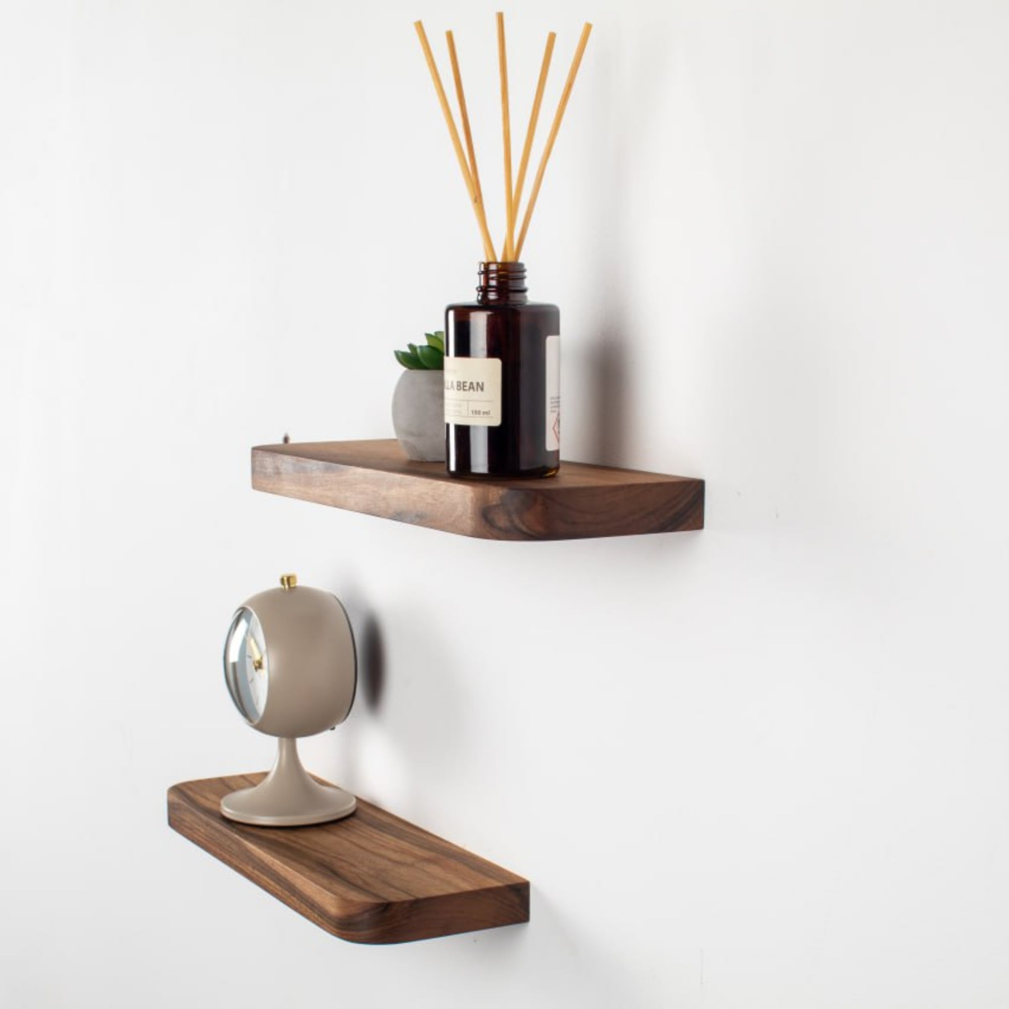 Wooden shelves with decorative items on a white wall