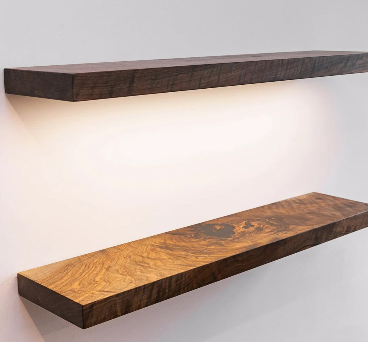 Wooden shelves with a wavy pattern on a white wall