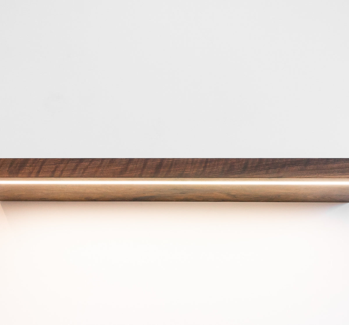 Wooden rod with a dark brown finish on a white background