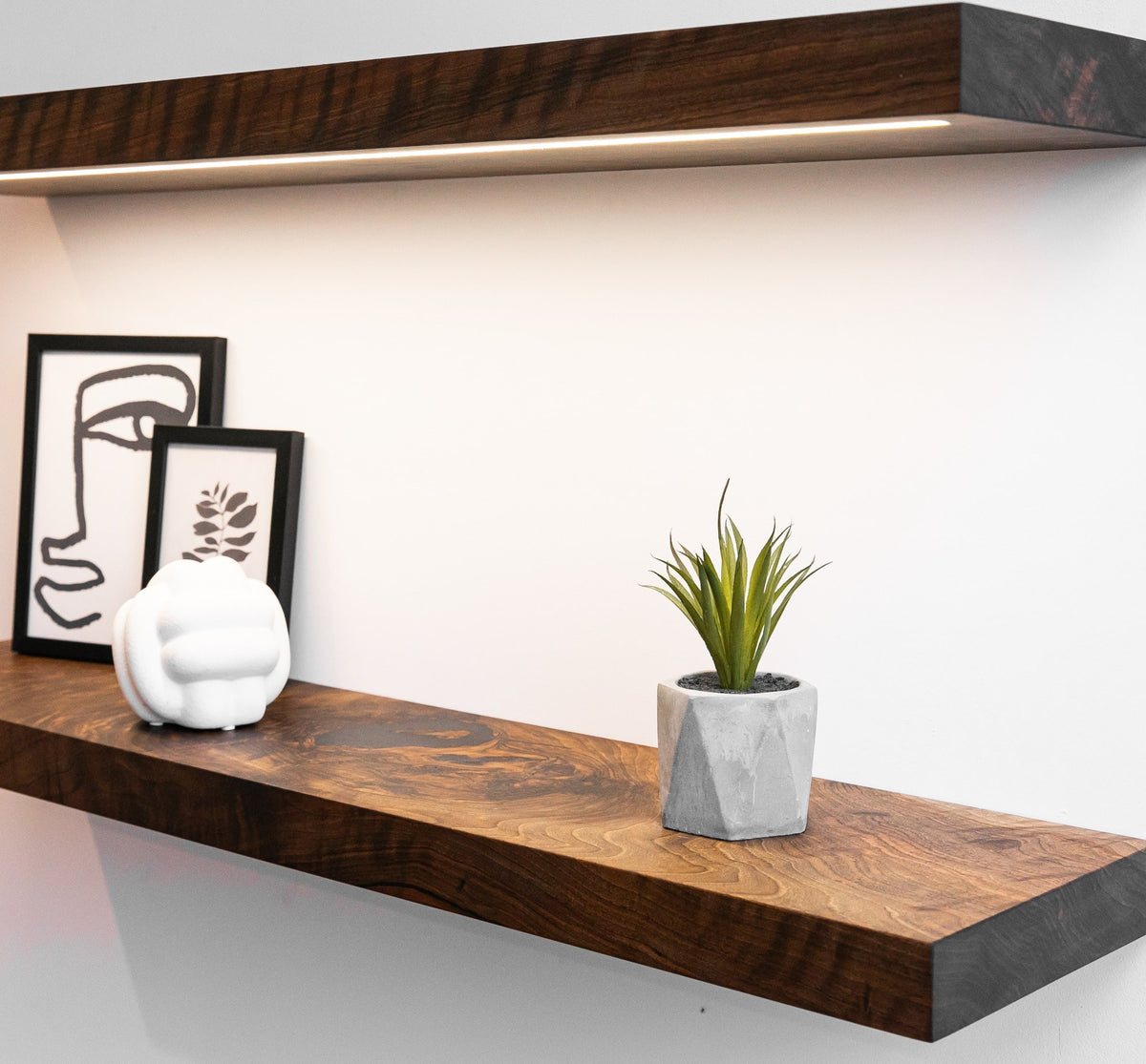 Wooden shelves with decorative items on a white wall