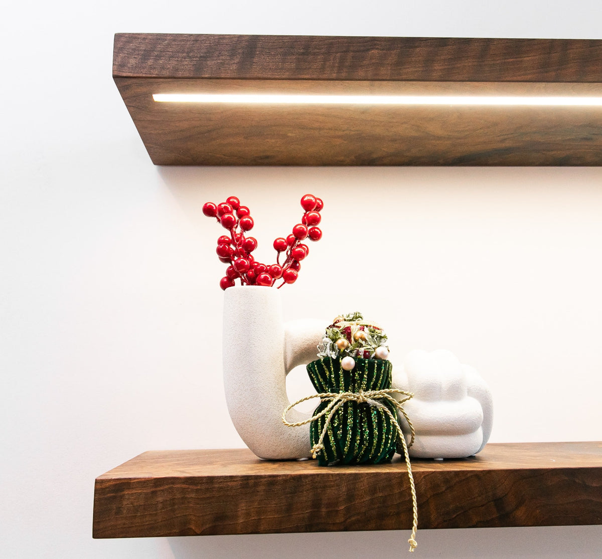 Decorative items on a wooden shelf with a white background
