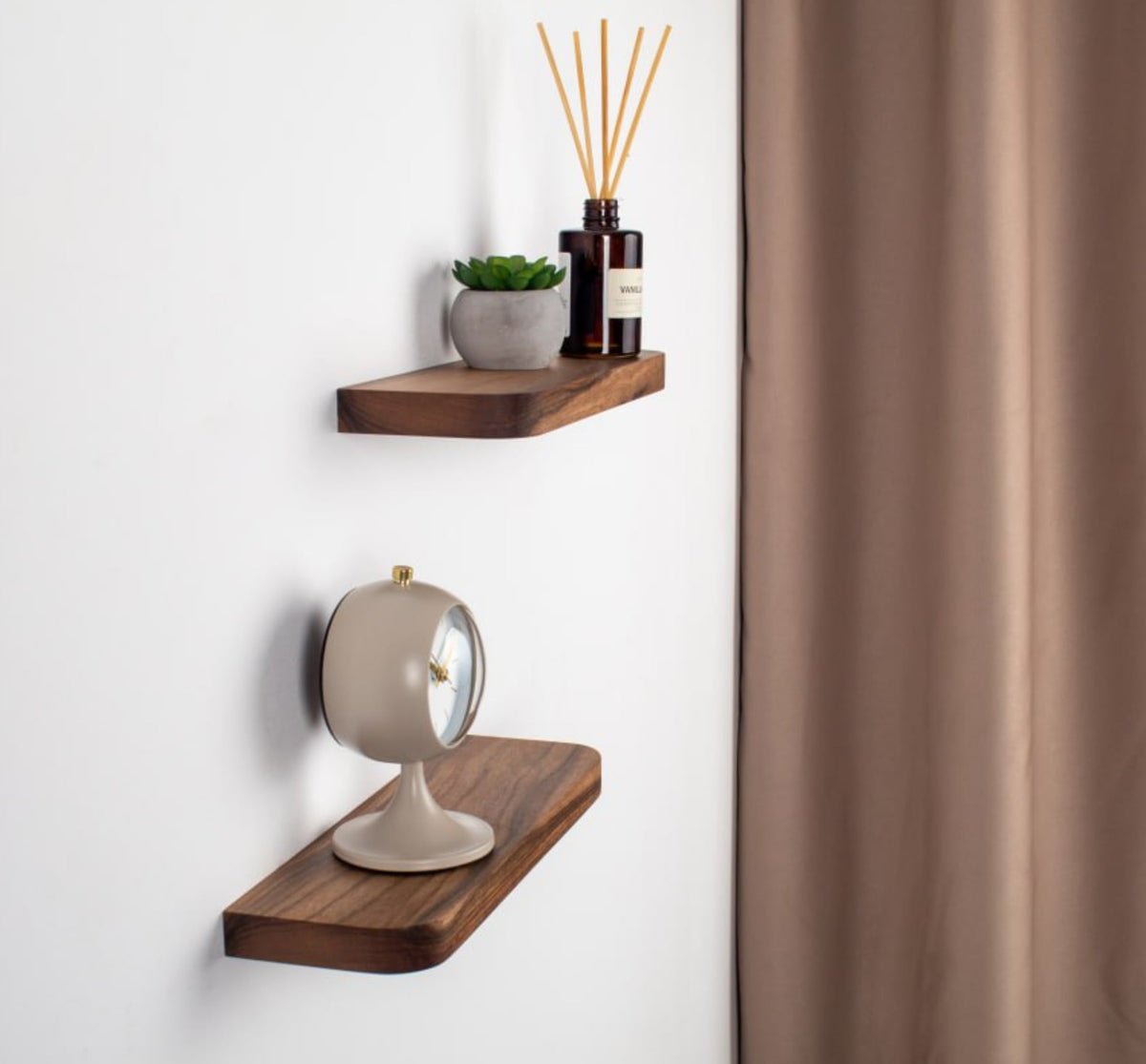 Wooden wall shelves with decorative items against a white wall.