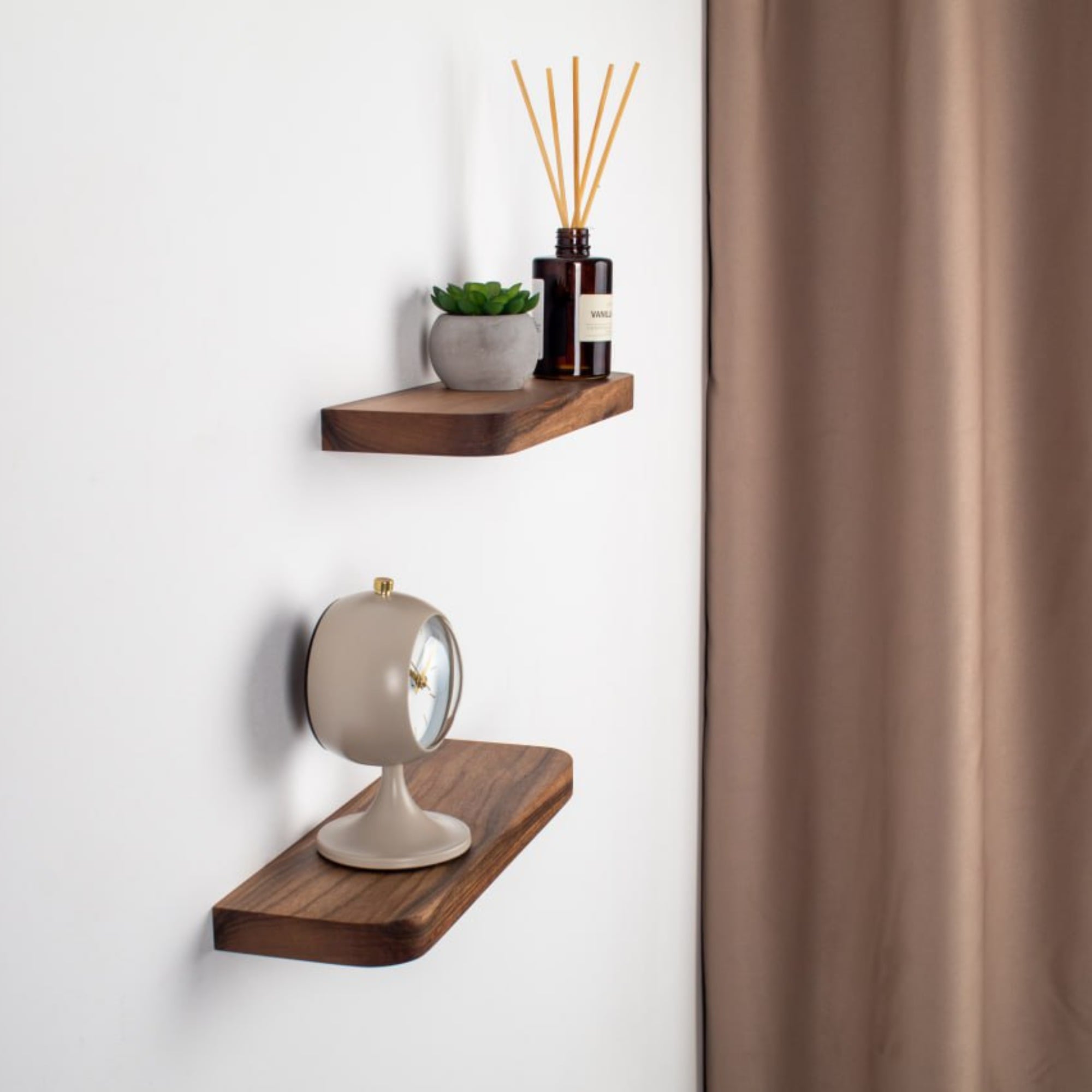 Wooden wall shelves with decorative items against a white wall.