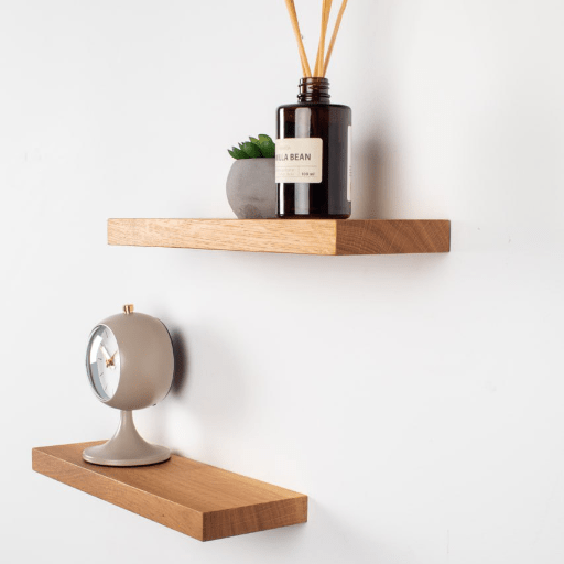 Wooden shelves with decorative items on a white wall