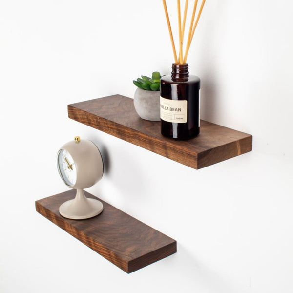 Wooden shelves with decorative items on a white background