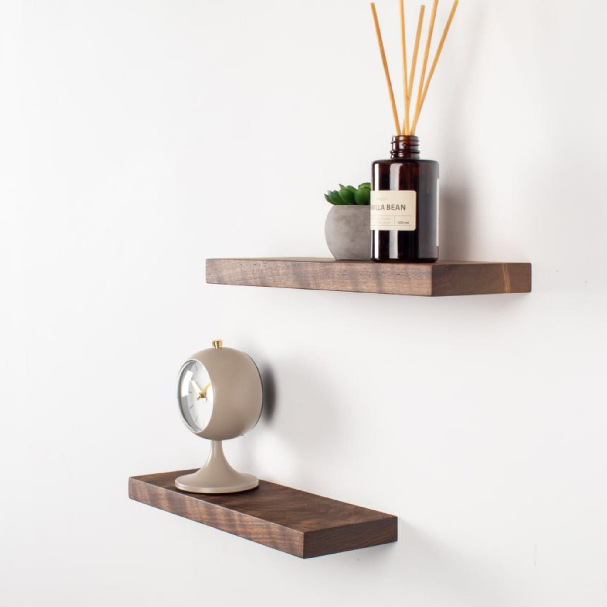 Wooden shelves with decorative items on a white wall