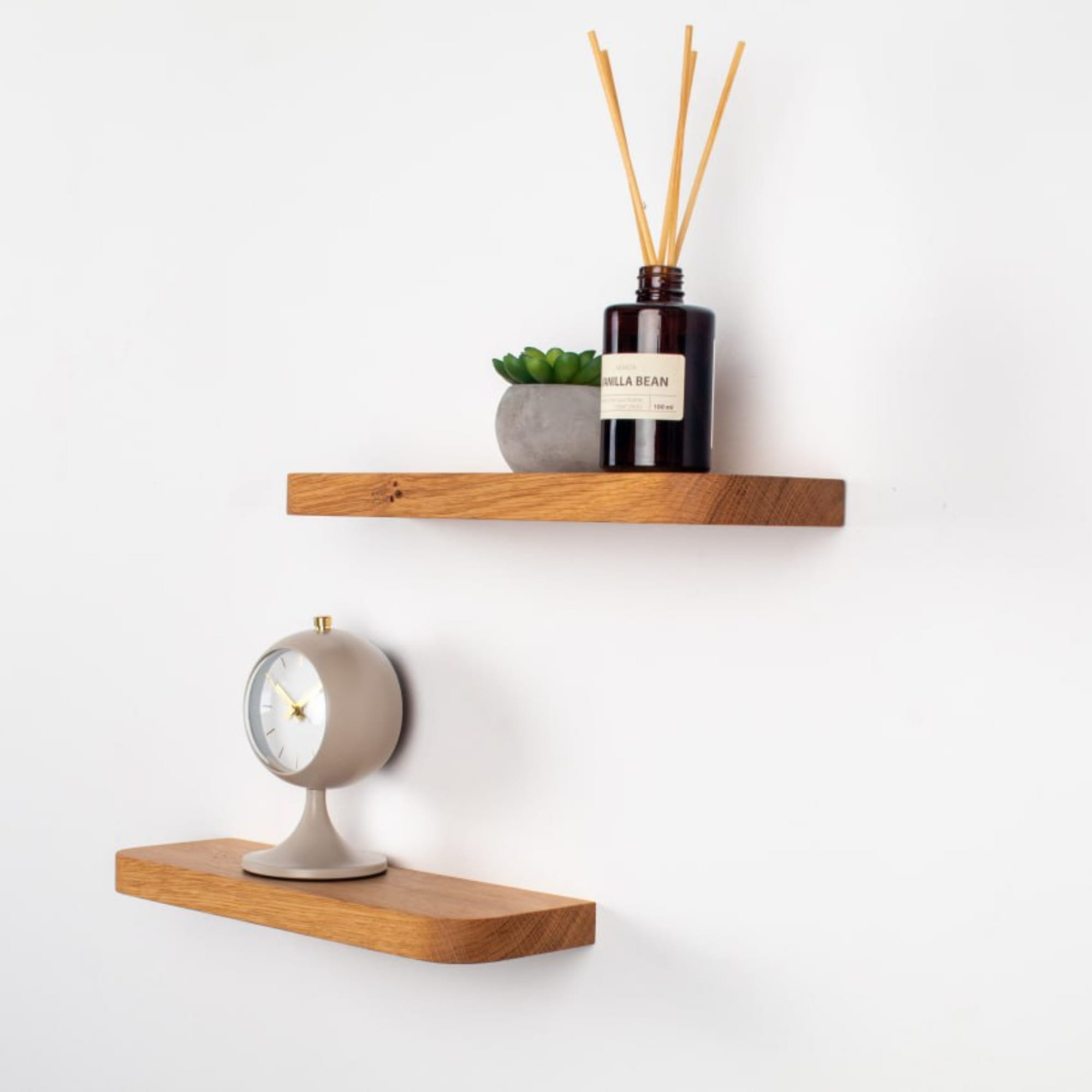 Wooden shelves with decorative items on a white wall
