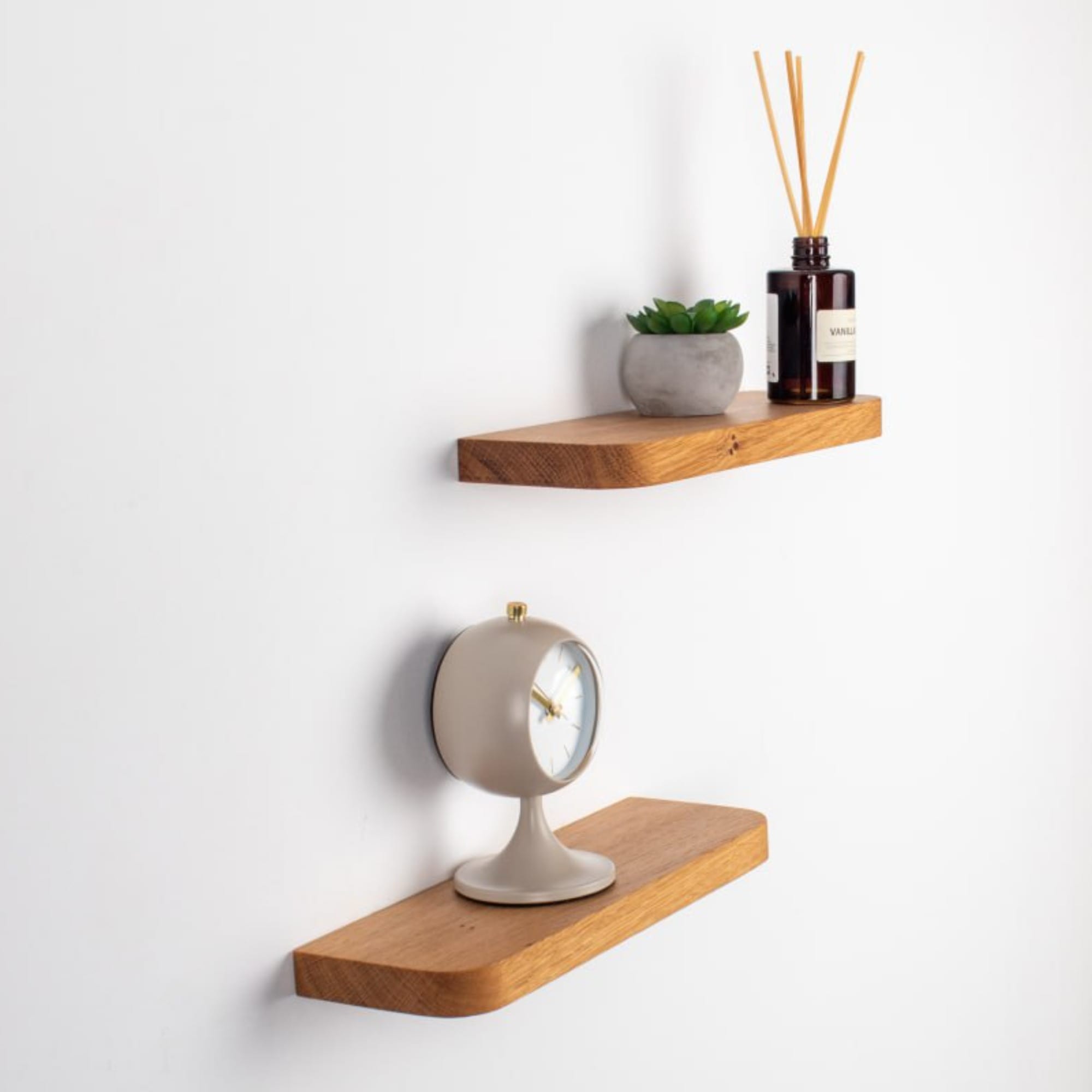 Two wooden shelves with decorative items on a white background