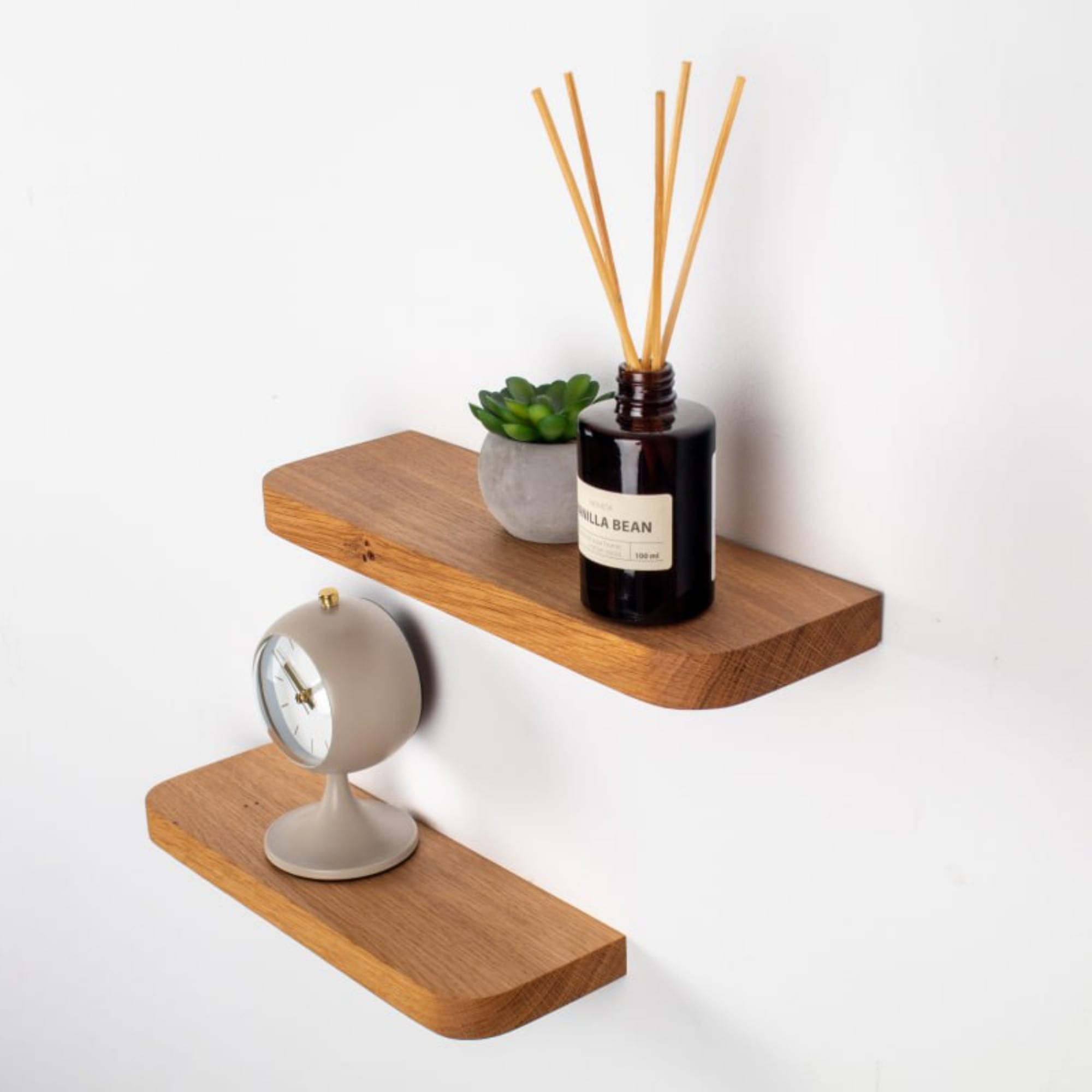 Wooden shelves with decorative items on a white background