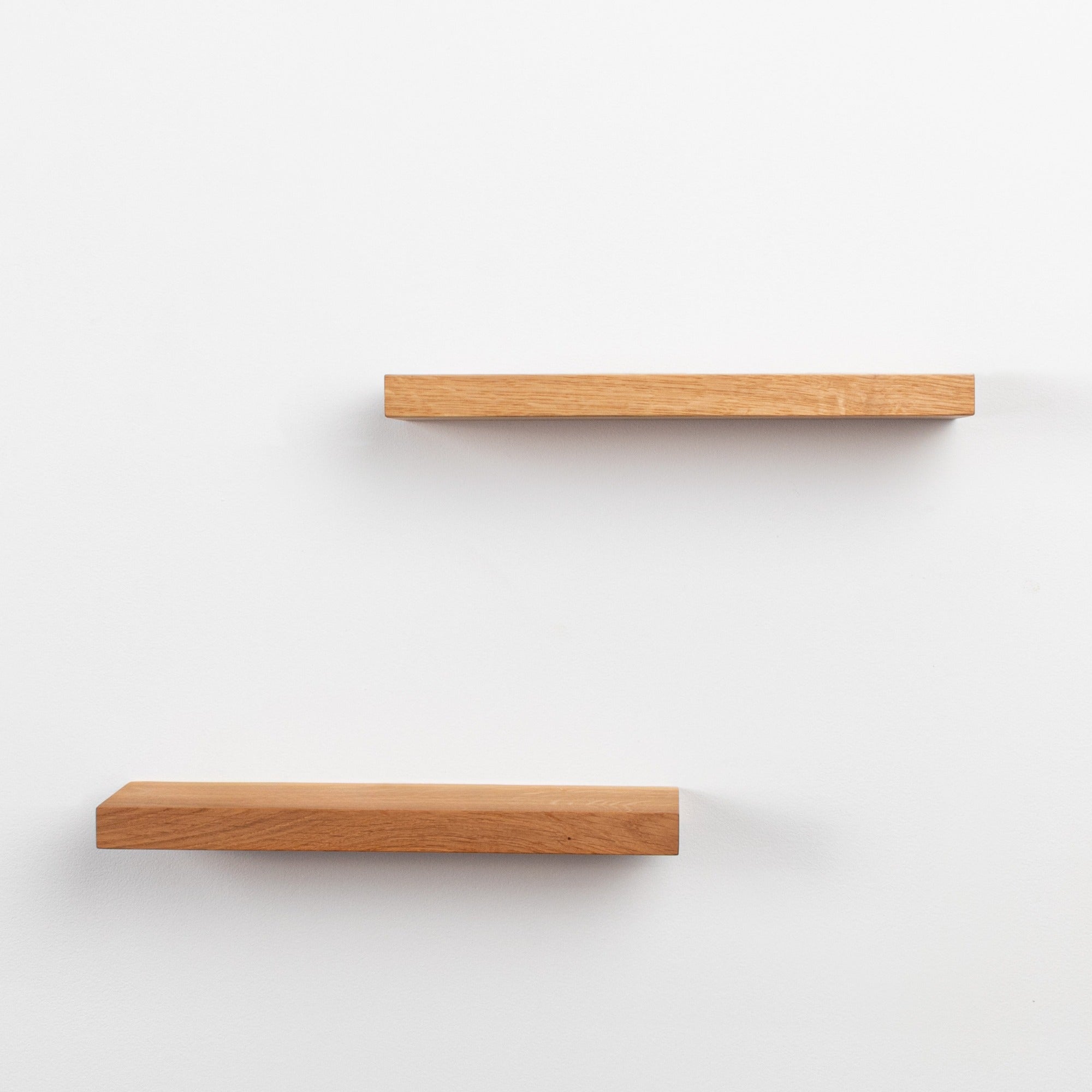 Two wooden shelves on a white background