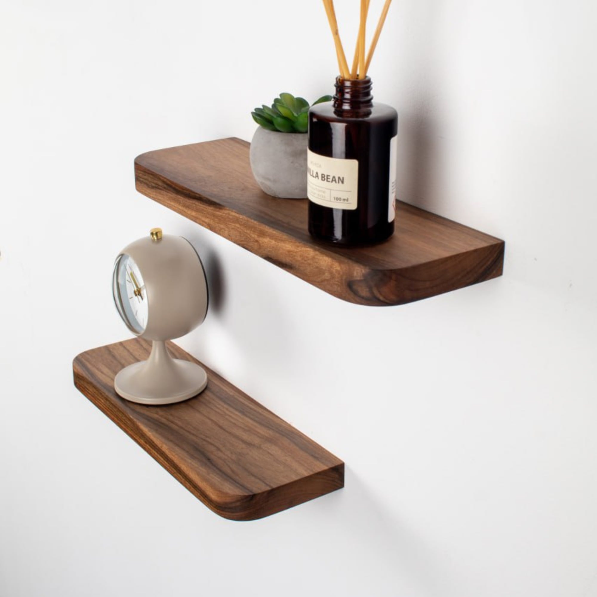 Wooden shelves with decorative items on a white background