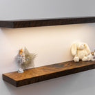 Wooden shelves with decorative items against a plain wall