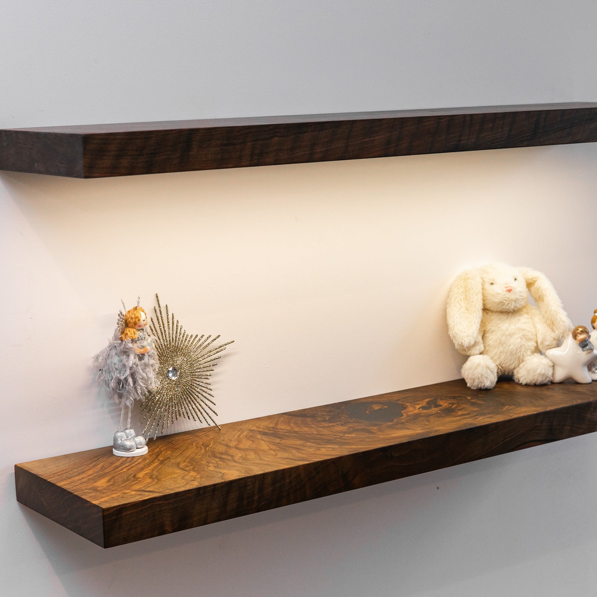 Wooden shelves with decorative items against a plain wall