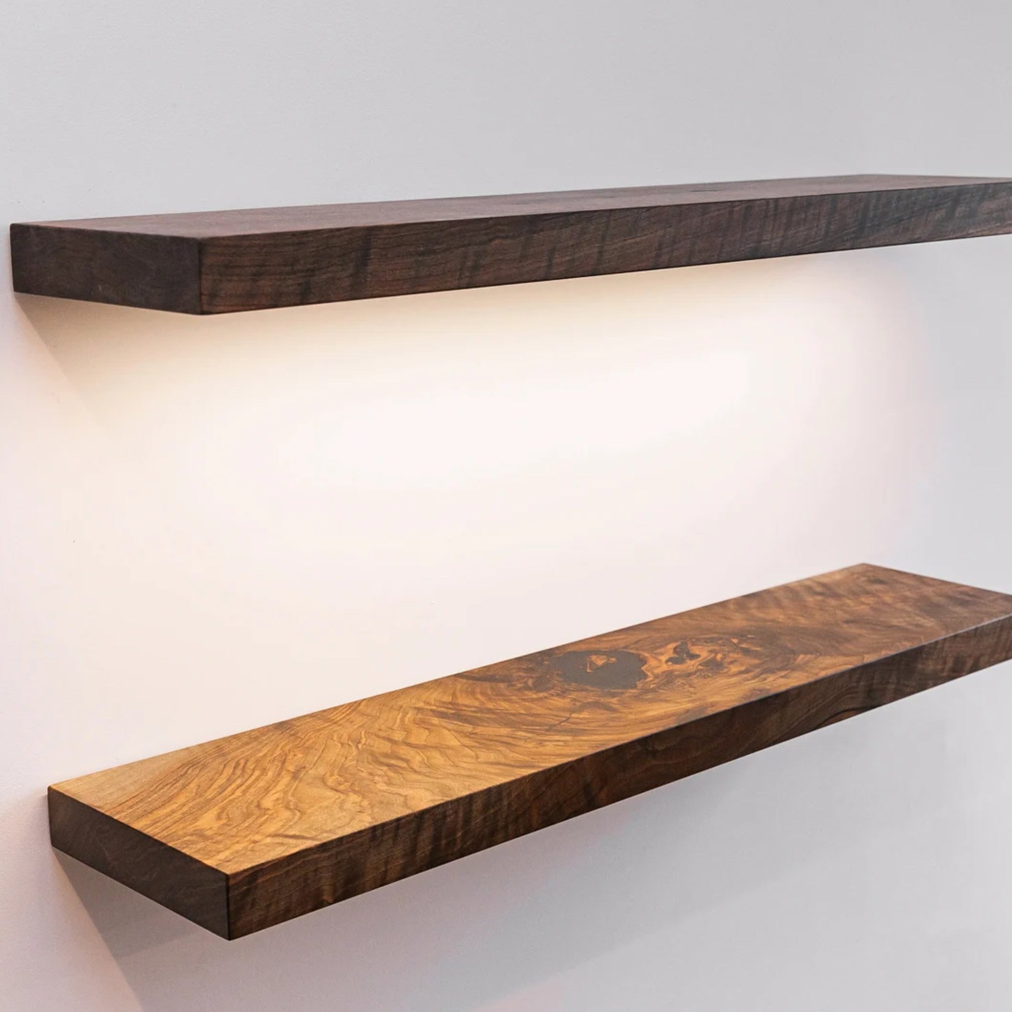 Wooden shelves with a wavy pattern on a white wall