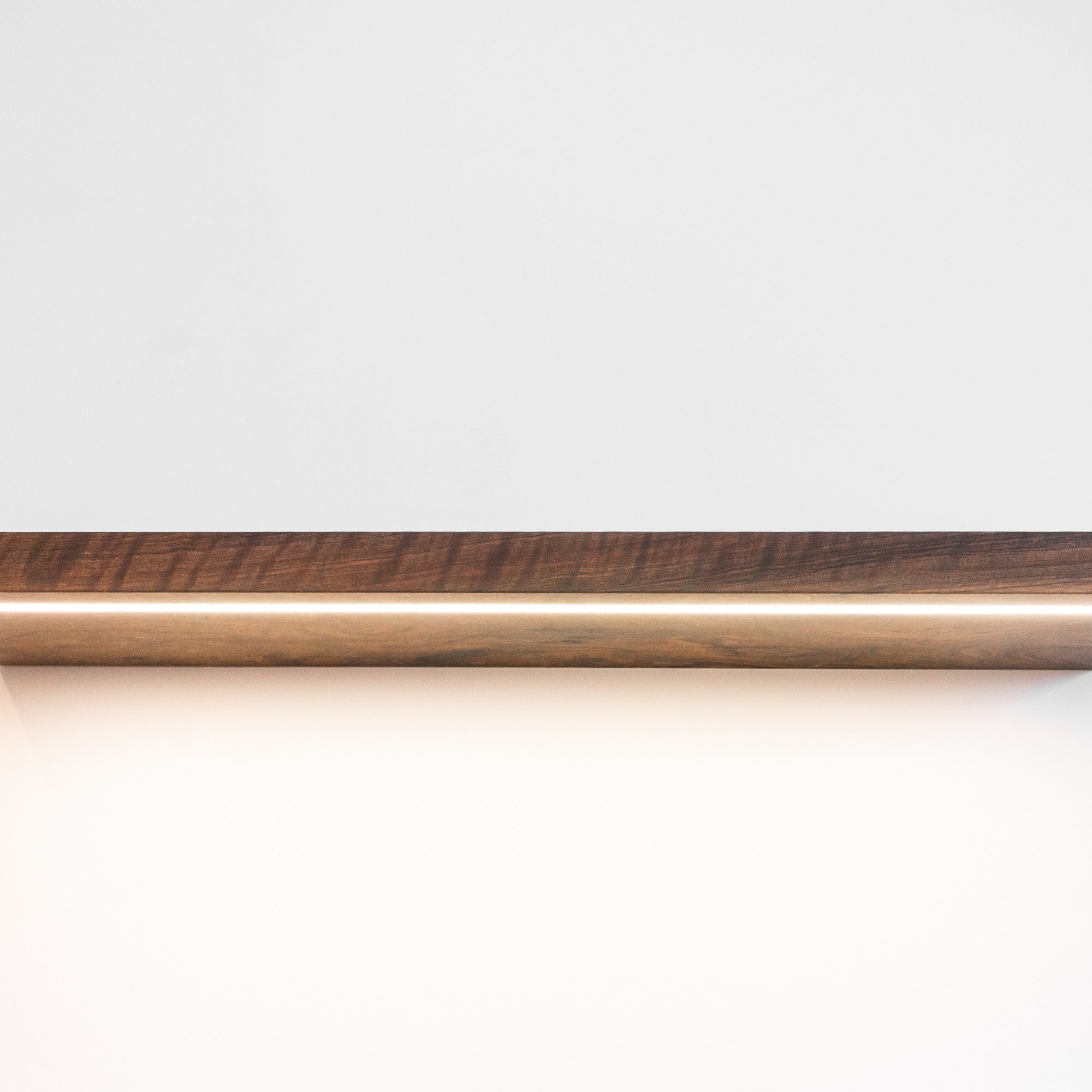 Wooden rod with a dark brown finish on a white background