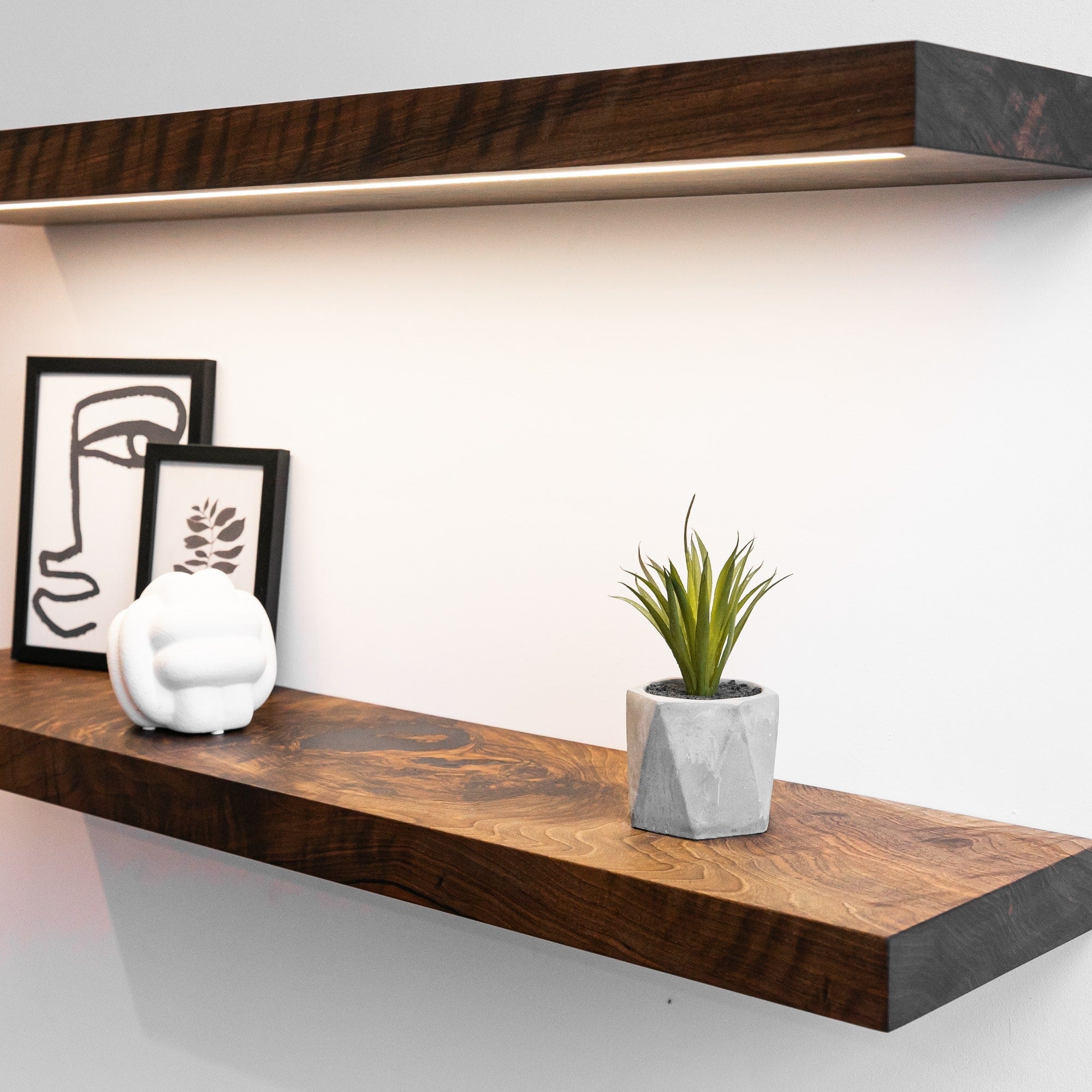 Wooden shelves with decorative items on a white wall