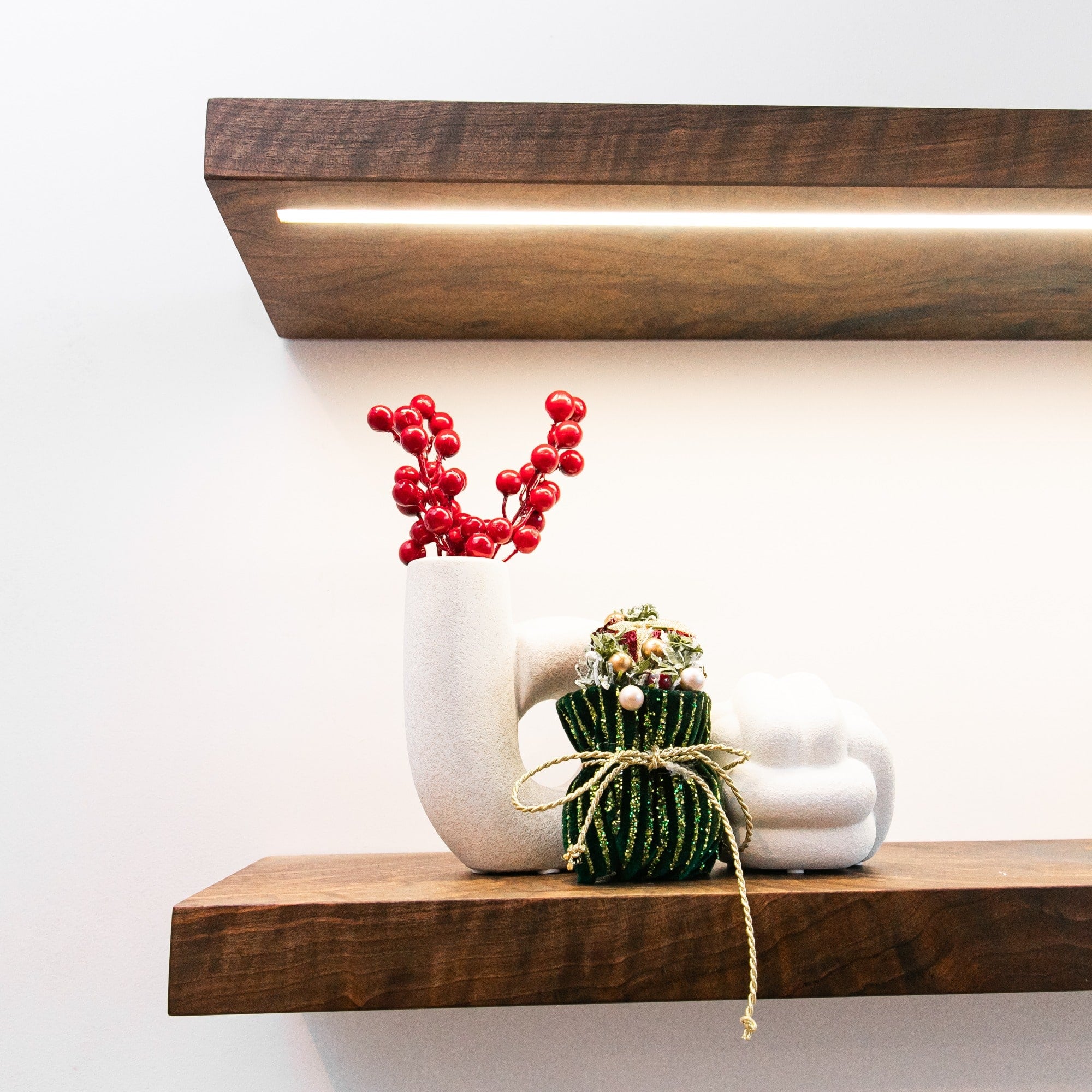 Decorative items on a wooden shelf with a white background